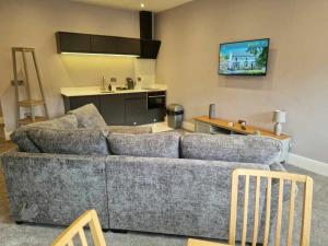 a living room with a couch and a kitchen at The County in Newton Aycliffe