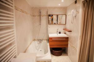 a bathroom with a shower and a tub and a sink at Appartement Tignes Val-Claret // 6 Personnes in Tignes