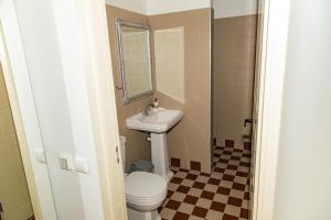 a bathroom with a sink and a toilet at Kaunas Embassy Apartments in Kaunas