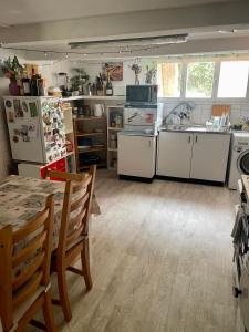 a kitchen with white appliances and a table at Cozy Room in an old Farmhouse near Vaduz in Sevelen