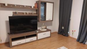 a living room with a flat screen tv on a entertainment center at Holiday Retreat Apartment - Zadar in Zadar