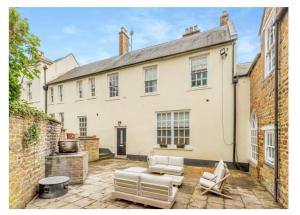 Cette grande maison blanche dispose d'une terrasse. dans l'établissement 8 bedroom Annexe at Moulton Grange, à Northampton