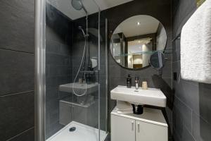 a bathroom with a sink and a mirror at Aparthotel Adagio Zurich City Center in Zurich