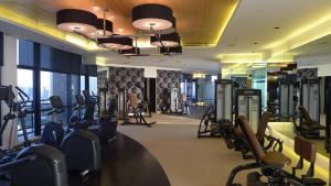 a gym with treadmills and exercise equipment in a building at The Gramercy Residences in Manila