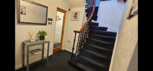 un corridoio con scala in una casa di Inverour Guest House a Spean Bridge