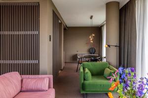 a living room with a couch and a table at Van der Valk Hotel Deventer in Deventer