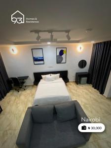 um quarto com uma cama grande e um sofá em 93 Homes and Residence (Shortlet Apartment in Abuja) em Abuja