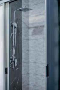 a shower in a bathroom with a glass door at Stay Simple Lodge in Lusaka