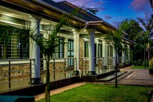 an exterior view of a house with columns at Stay Simple Lodge in Lusaka