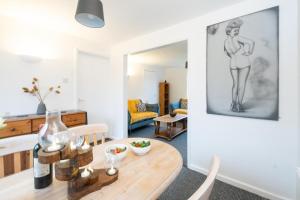 a living room with a table and chairs and a living room with a drawing at Hollybobs in Leiston