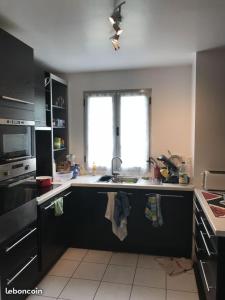 a kitchen with a sink and a stove top oven at chambre d'hote Disneyland esprit in Bussy-Saint-Georges