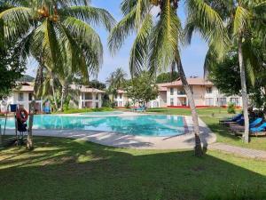 an image of a swimming pool with palm trees at PANORAMA RESORT LANGKAWI in Kuah
