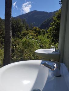 a bathroom sink with a view of a mountain at La Pause Mafate in La Possession