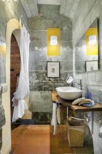 La salle de bains est pourvue d'un lavabo et d'un comptoir avec un miroir. dans l'établissement Villa Vignacce - Boutique Country Resort, à Bettolle