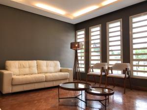 a living room with a couch and a table and chairs at Nap Hotel in Ponta Grossa