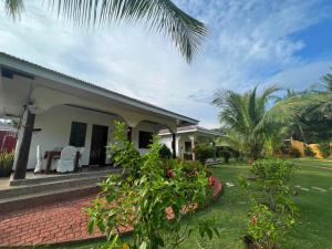 a house with a porch and a yard at E&N Paradise Island Resort in Siquijor