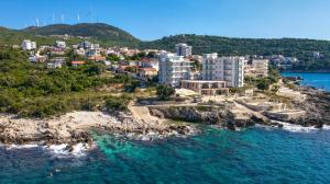 an aerial view of a resort on a rocky island in the ocean at Open Sea Apartments in Utjeha