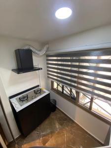 a kitchen with a stove and a window at 93 Homes and Residence (Shortlet Apartment in Abuja) in Abuja