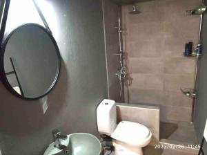 a bathroom with a mirror and a toilet and a sink at House of South in Yiannioú