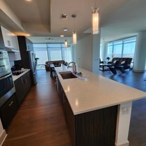 a kitchen and living room with a sink and a counter at Latitude Med Center in Houston