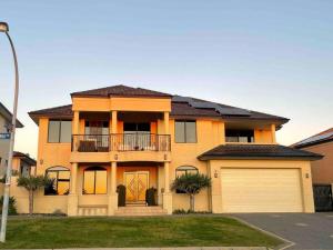 a large orange house with a garage at Perth 2-Story, Views, BBQ & More in Perth