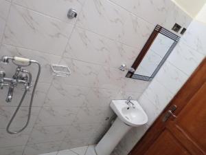 a bathroom with a sink and a mirror at Safari Lake view apartments, Muyenga in Kampala