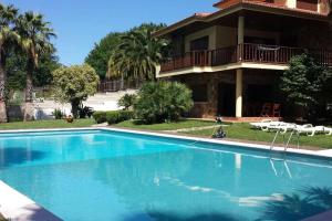 a large swimming pool in front of a house at Casa Nora in Gondomar