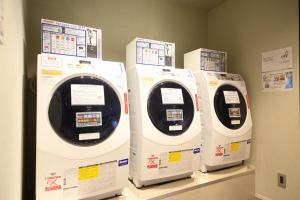 three washing machines are on display in a store at Dynasty Hotel & Resort Osaka in Osaka