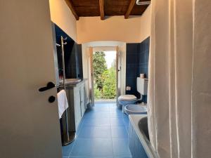 a bathroom with a tub and a toilet and a sink at Kibilù - Via Robarello - Sacro Monte in Varese