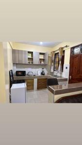 a kitchen with wooden cabinets and a counter top at MAXIMILIAN HOMES in Kilifi