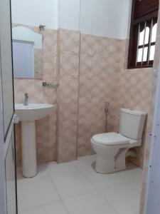 a bathroom with a toilet and a sink at VILLA GREEN VILLAGE in Kamburugamuwa