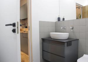 a bathroom with a sink and a toilet in it at Mini Home Bookshop Studios in Vilnius