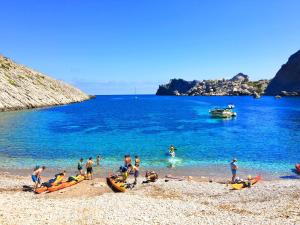 un grupo de personas en una playa cerca del agua en Villa Cal Roma, en Pollensa