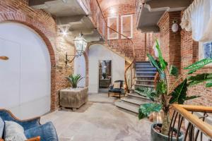 a brick hallway with stairs and a brick wall at Lucca Heritage Retreat in Lucca