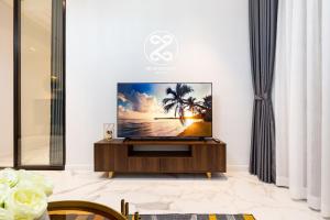 a living room with a flat screen tv on a stand at METROPOLE -Central Saigon Riverside -Free POOL-GYM-SAUNA Room-YOGA Room in Ho Chi Minh City