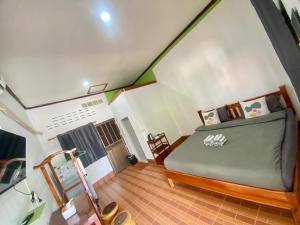 a bedroom with a bed in a attic at บ้านคุณโต้ง เชียงคาน BaanKhunTong ChiangKhan in Chiang Khan