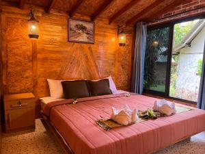 a bedroom with a bed with two pillows on it at Klong Jark Bungalows in Ko Lanta