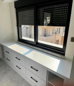 a white dresser with a window in a room at New apartment by Cleopatra in Alanya
