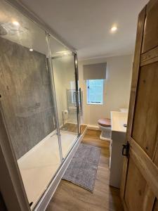 a bathroom with a shower and a toilet at The Cottage, 13 Golden Sq. in Kent
