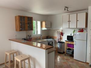 uma cozinha com um balcão e um frigorífico branco em Maison Familiale Proche Plage, Marché & Commerces - 6 pers. Classée 3 étoiles em La Brée-les-Bains