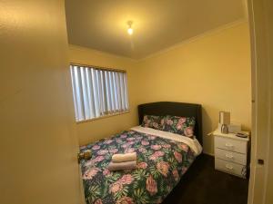 a small bedroom with a bed and a window at 5 Beds-Whole House-Carrum Beach- Patterson Lake-Fully Furnished in Carrum