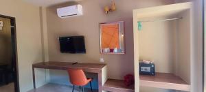 a room with a desk with a chair and a mirror at Fill - Feel @ Long Beach Resort in Ko Lanta