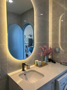 a bathroom with a sink and a mirror at KB Villas in Bình Sum