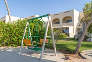 a swing in front of a building at Radwa Ramadh Resort in Yanbu