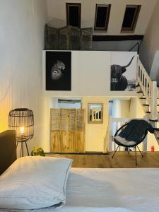 um quarto com uma cama e uma escada em Monumentale stadswoning in hartje binnenstad em Maastricht