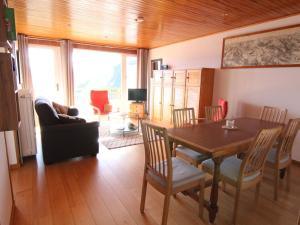 a living room with a dining room table and chairs at Appartement Huez, 3 pièces, 6 personnes - FR-1-405-69 in L'Alpe-d'Huez