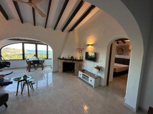 a large living room with a bed and a fireplace at Casa Moya Moraira - Seaview Villa in Teulada