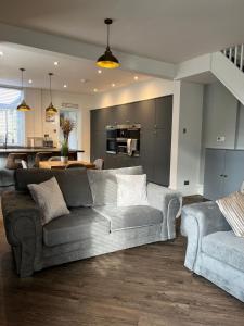 a living room with a couch and a kitchen at Castle View House in Clitheroe