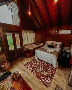 a bedroom with a bed and a tub in it at Cabanas Vale Verde in Praia Grande
