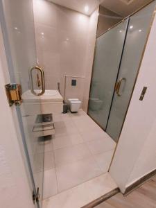 a bathroom with a shower and a toilet at Smayah Hotel in Riyadh